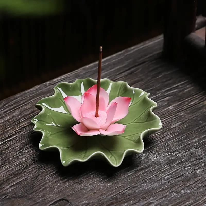 Green ceramic lotus-leaf dish with a pink lotus blossom, holding an incense stick on a wooden table (seller photo from the AliExpress listing)