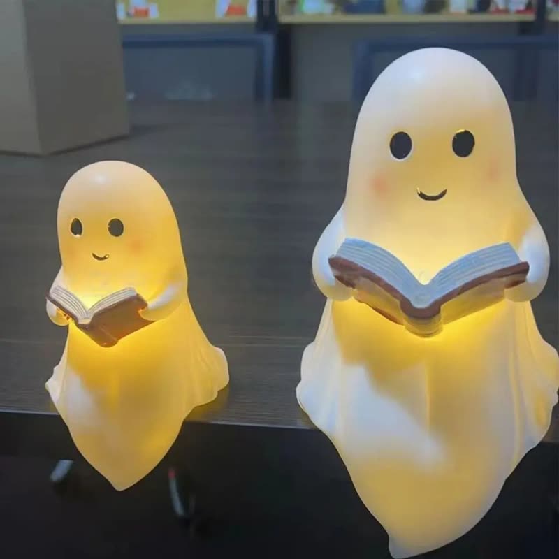 Two glowing white ghost night lights, each holding an open book (seller photo from the AliExpress listing)