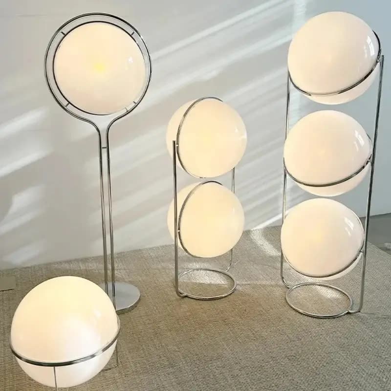 Several globe floor lamps with slim chrome frames and glowing white acrylic ball shades in different heights (seller photo from the AliExpress listing)