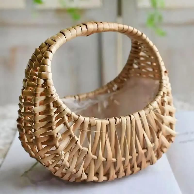 Small woven willow rattan basket with a curved handle on a table (seller photo from the AliExpress listing)